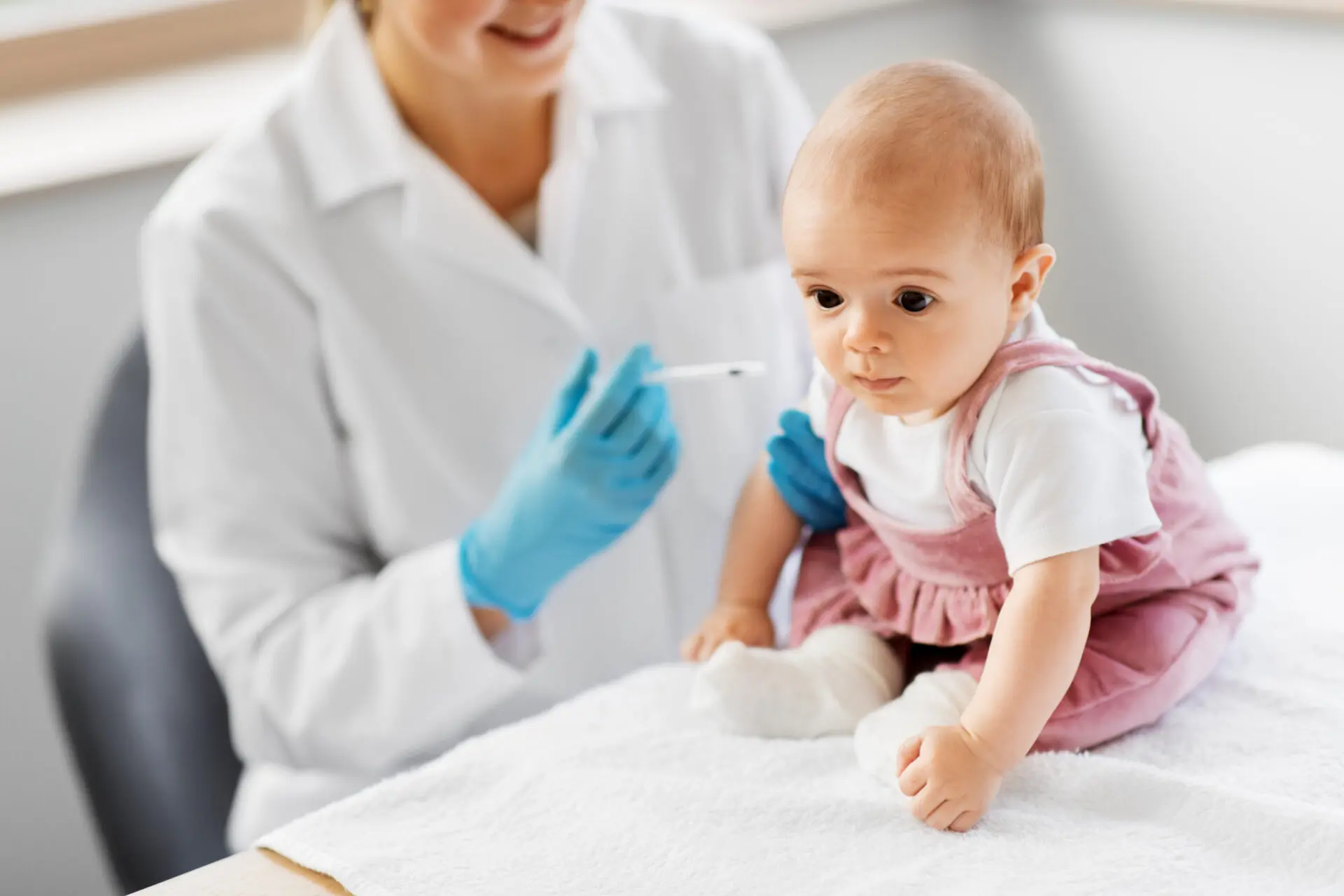 doctor making vaccine for baby patient at clinic baby girl getting a vaccine from a healthcare professional