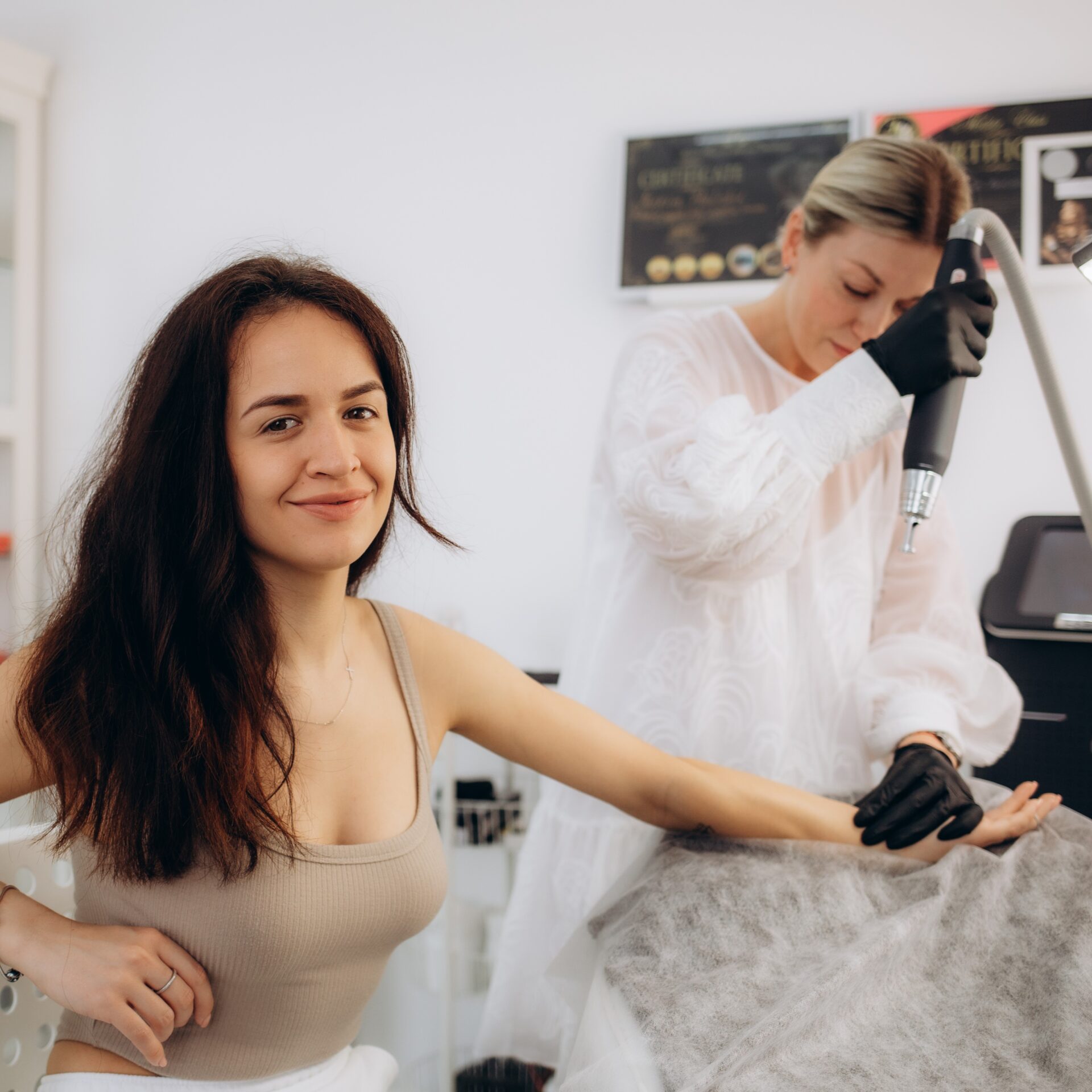 woman getting a tattoo laser removal